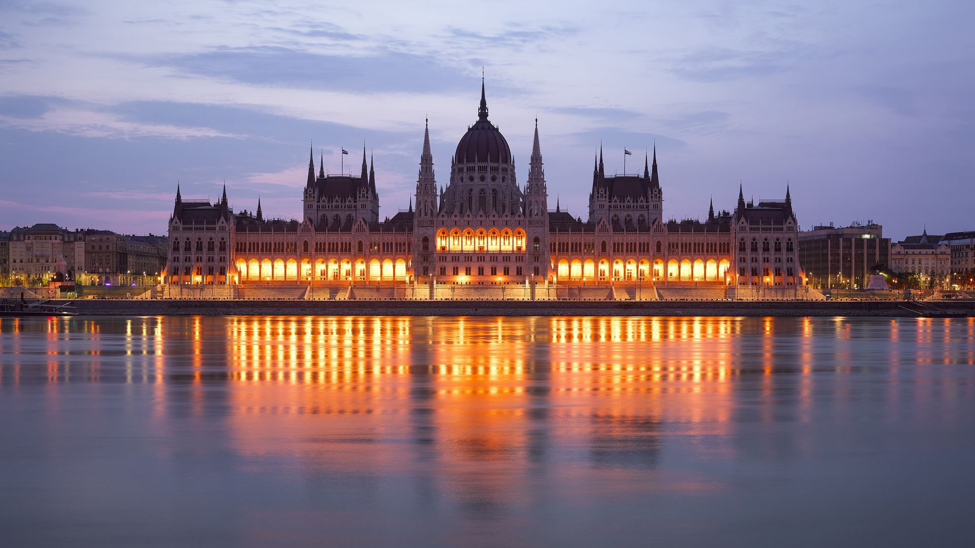 The Danube flowing past the Hungarian Parliament in Budapest at dusk